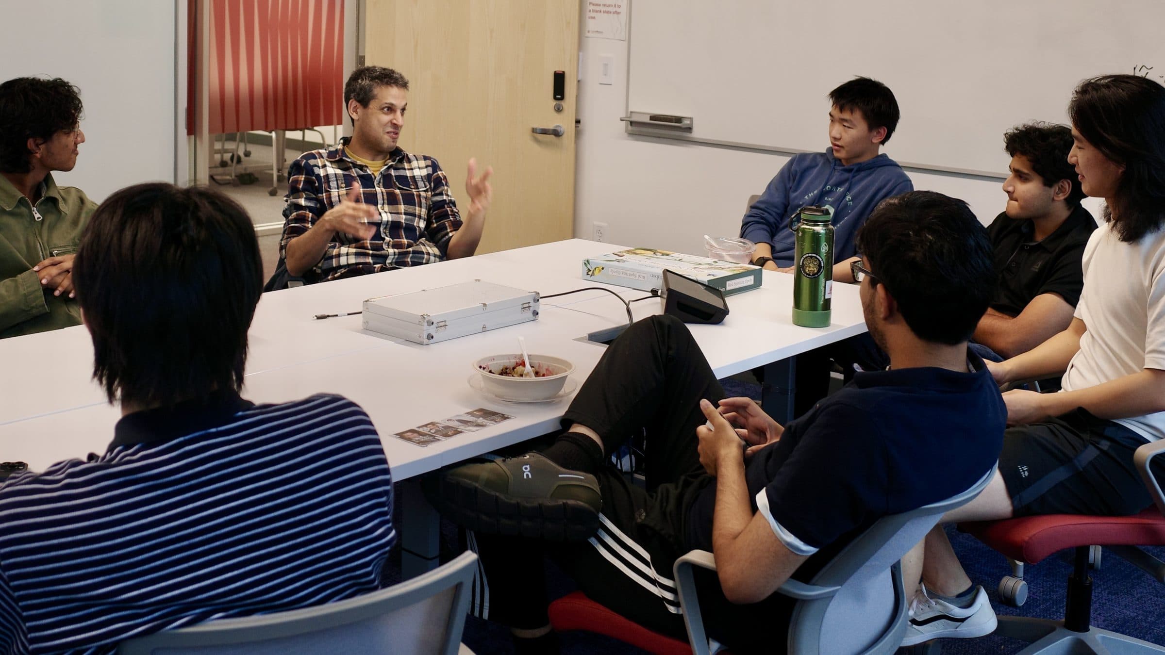 CAIA members in a discussion around a seminar table