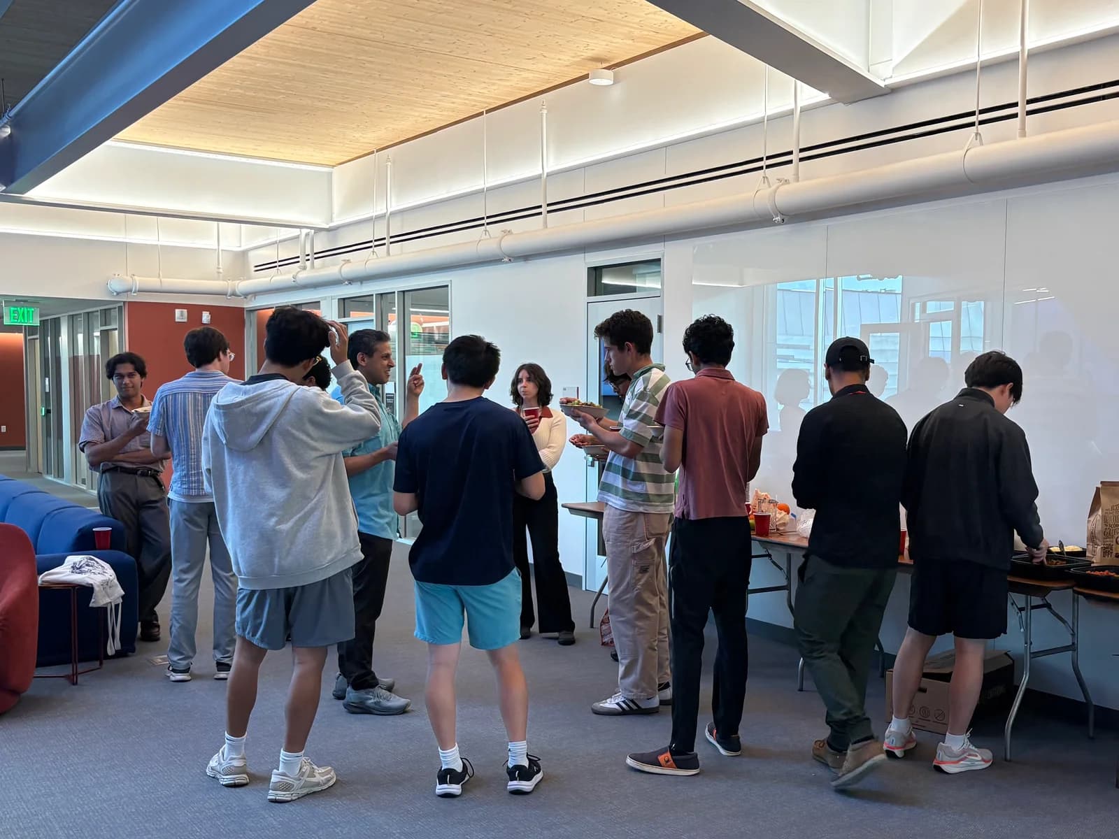 Attendees chatting over refreshments at the CAIA open house and mocktail mixer